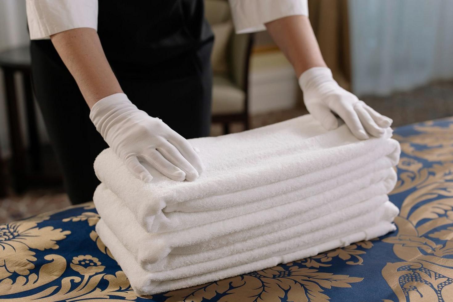 Housekeeper preparing clean towels